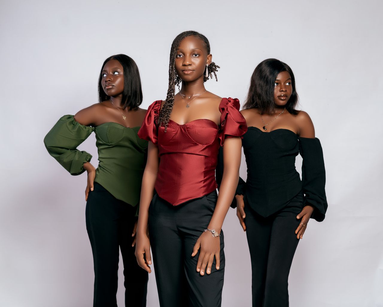 Services Stylish portrait of three women in elegant off-shoulder tops, showcasing modern fashion and confidence.
