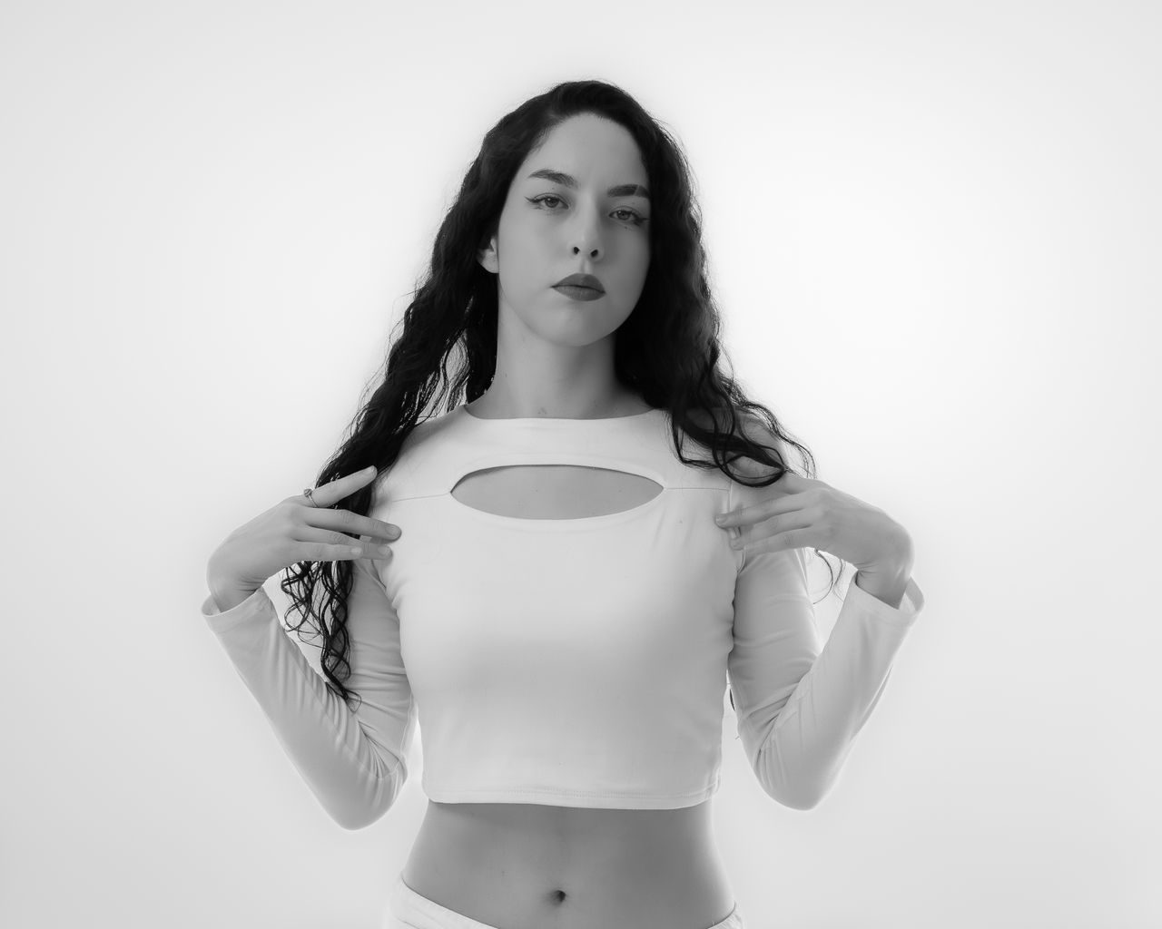 Striking black and white portrait of a fashionable woman in a stylish pose.